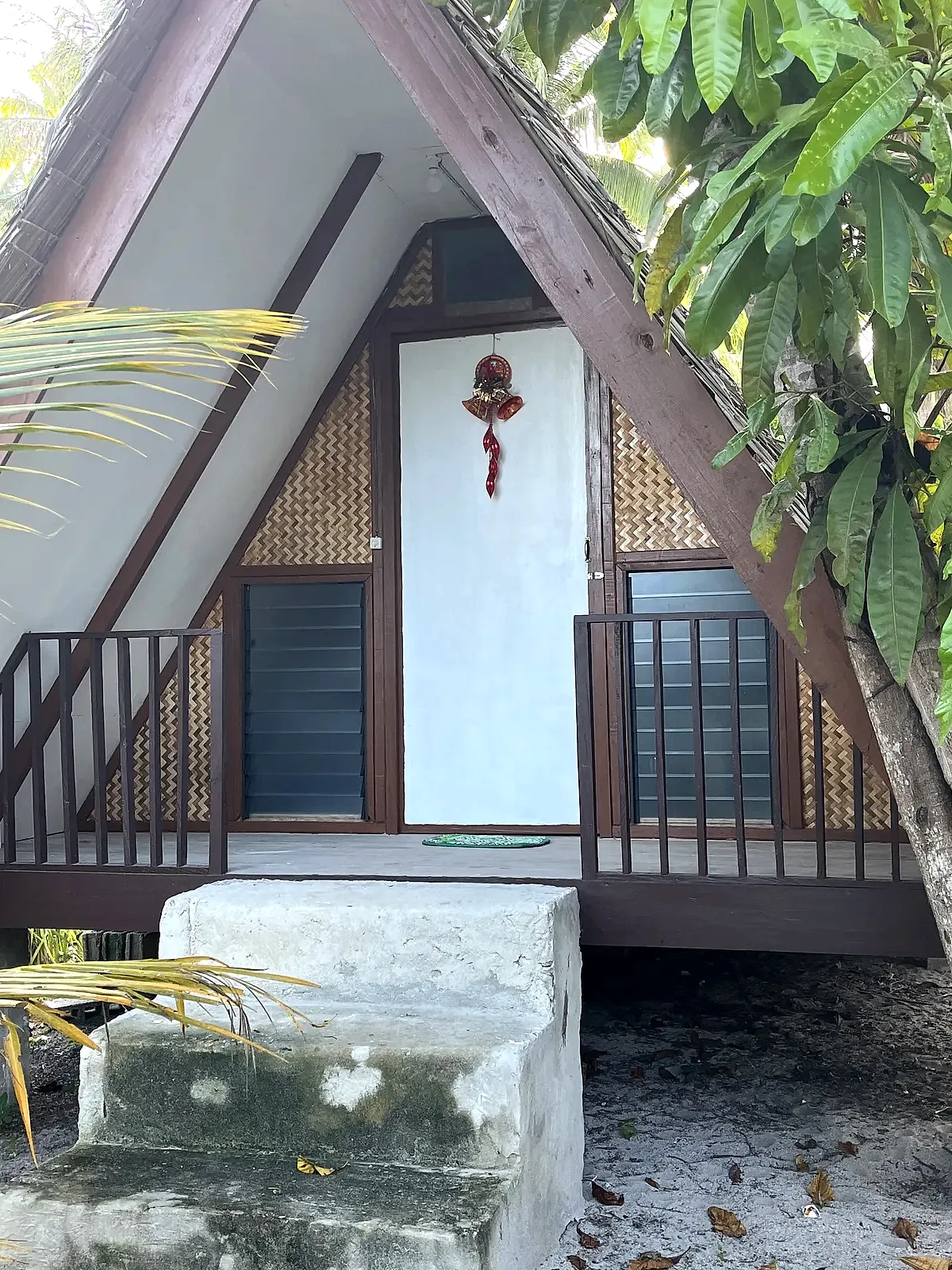 Beachfront native kubo hut with a thatched roof at the shoreline