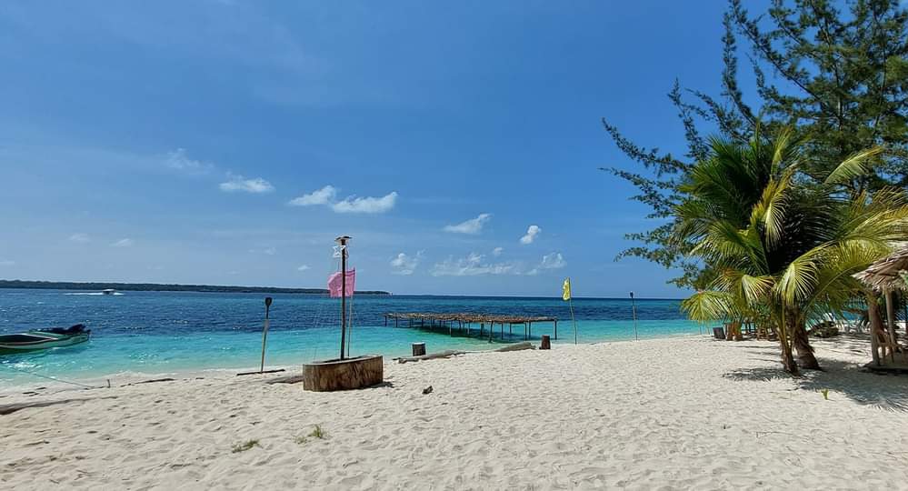 Clear shallow waters lapping a white sand beach